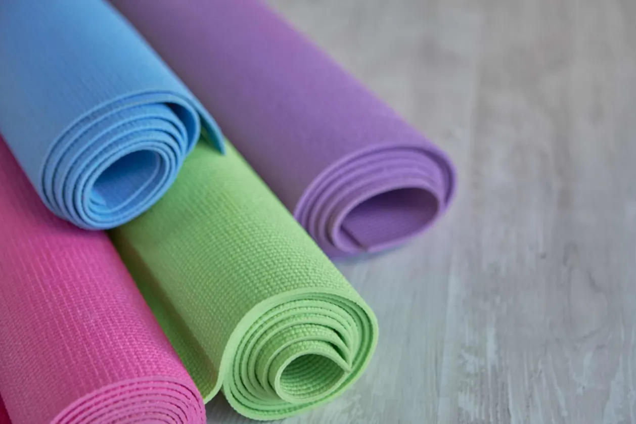 colorful rolled travel yoga mats